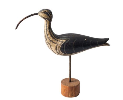 *Guy Taplin [b.1939] a driftwood sculpture of a Curlew: modelled standing on one leg on a circular base, with inset glass eye