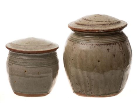*Richard Batterham (b.1936) two stoneware jars and covers:  of 'beaten oviform the shoulders with horizontally incised linear
