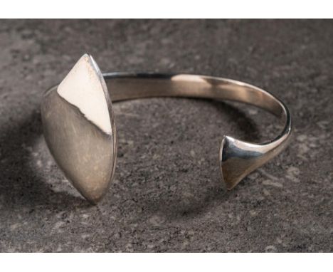 Georg Jensen. A torque bangle of plain tapering design: stamped '925 Denmark' and with oval Georg Jensen stamp, approximately