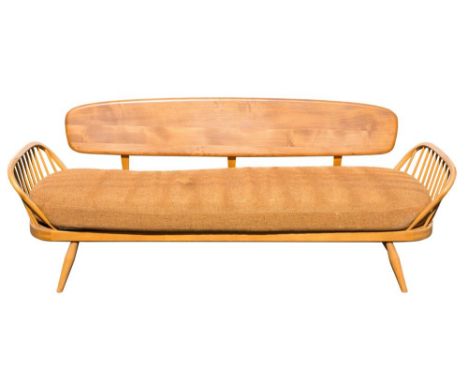 An Ercol elm and beech settee, circa 1960s: with a shaped solid back and Windsor -style stick back angled ends, the Ercol Sho