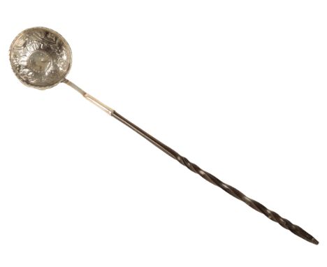 A VICTORIAN WHITE METAL AND HORN TODDY LADLE apparently unmarked, the circular bowl with repoussÃ© decoration, inset with coi