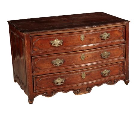 A FRENCH WALNUT SERPENTINE COMMODE 19th century, with moulded long drawers, above a carved and shaped apron, on bun feet, 73c