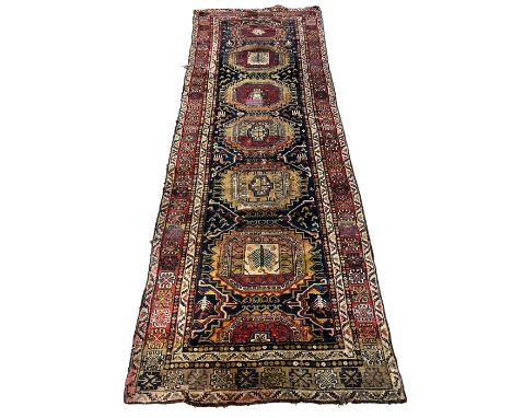 A NORTH PERSIAN RUNNER 20th century, with repeating central medallions, 340cm x 120cm (with repairs)