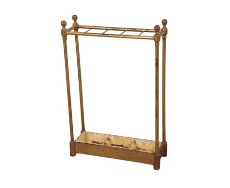 A BRASS STICK STAND early 20th century, with turned finials, and a painted drip tray, 61cm high x 42cm wide x 15cm deep