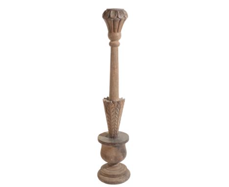 AN ECCLESIASTICAL OAK CANDLESTICK 19th century, with a carved tapering stem, with socle base, 70cm high
