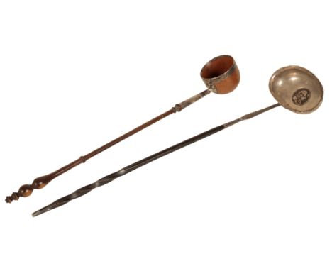 A GOURD AND WHITE METAL MOUNTED TODDY LADEL 19th century, with a turned handle, 33cm long, together with another white metal 