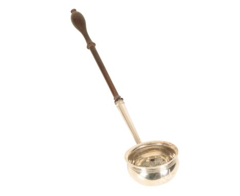 A SILVER TODDY LADLE by William Gwillim, London, 1751, with a circular bowl, ribbed border and turned wood handle , 30cm long