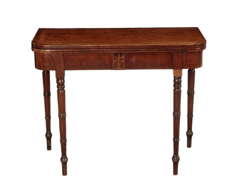 A REGENCY MAHOGANY CARD TABLE early 19th century, the hinged top opening to a baize lined interior, on ring turned tapering l