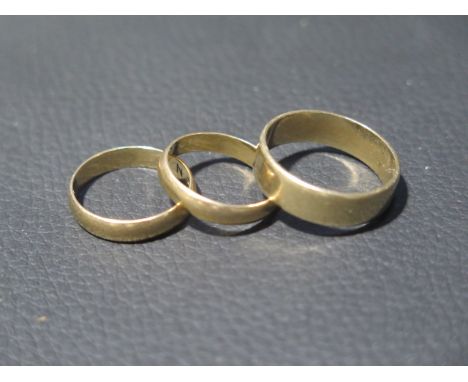 Three 9ct yellow gold wedding bands sizes R/S, M &amp; L - total weight approx 7.9 grams 