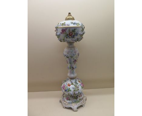 A Continental floral encrusted porcelain oil lamp stand - Height 61cm - some foliate losses and firing crack but generally go