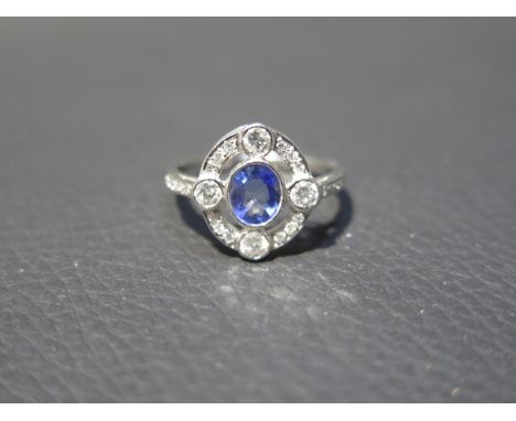 A platinum Art Deco style sapphire and diamond ring - head size approx 14mm x 13mm with diamond shoulders - ring size approx 