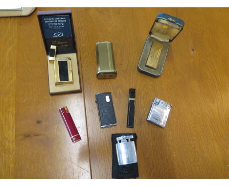 A Dupont lighter boxed, a Dunhill and six others 
