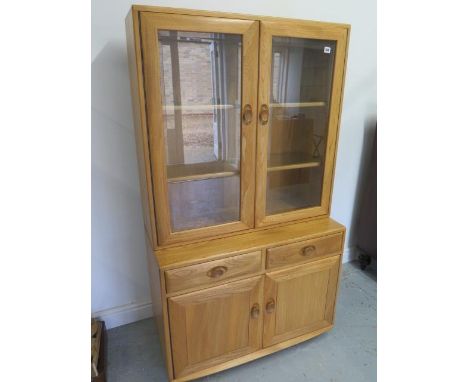 A blonde Ercol cabinet bookcase - in good condition - Height 160cm x Width 92cm 