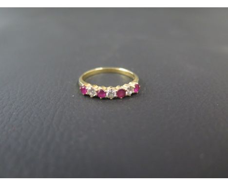 An 18ct yellow gold ruby and diamond bridge ring size Q/R - weight approx 3.3 grams 