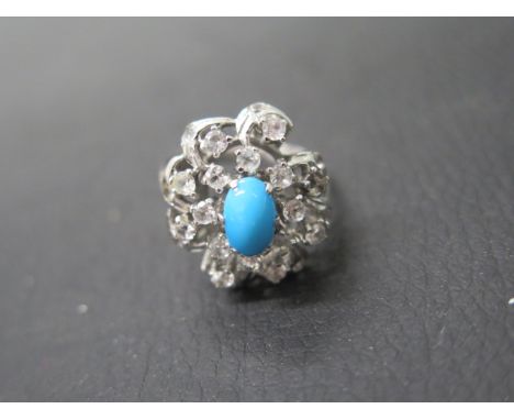 A 14ct white gold (unmarked but tested) ring with turquoise white sapphire - ring size R - weight approx 6.9 grams 