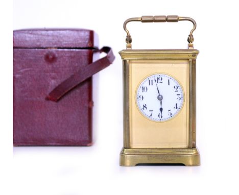 AN EARLY 20TH CENTURY BRASS CASED CARRIAGE CLOCK with white enamel dial and black Arabic numerals, impressed numerals to reve