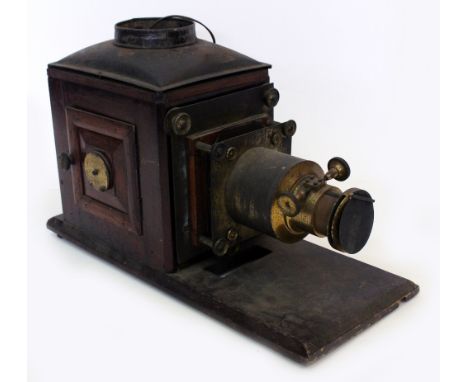 A VICTORIAN MAGIC LANTERN with brass lens converted for electricity together with a quantity of magic lantern slides to inclu