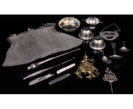 A WHITE METAL CHAIN BAG and folding fruit fork, button hooks, white metal dishes and three silver caddy spoons, one with mark