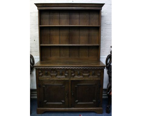 A 19TH CENTURY OAK DRESSER with plate rack above two short drawers and two panelled doors, raised on bracket feet, 108cm wide