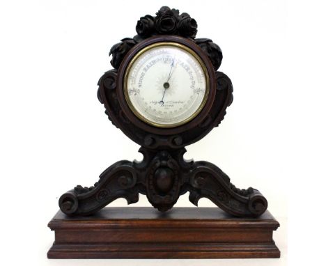 A NEGRETTI & ZAMBRA TABLE STANDING BAROMETER on mahogany carved base with acanthus scrolling leaf and carved floral decoratio
