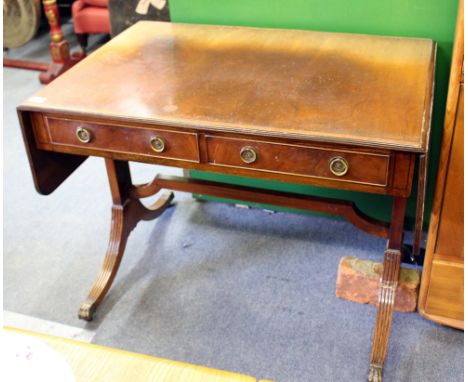 A GEORGIAN STYLE MAHOGANY SOFA TABLE  with two frieze drawers, reeded legs and cast hairy paw feet and castors 89.5cm wide x 