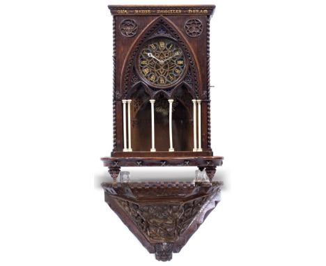 AN OAK GOTHIC REVIVAL BRACKET CLOCK  with chip carved decoration to the case and with outset turned ivory pilaster columns, t