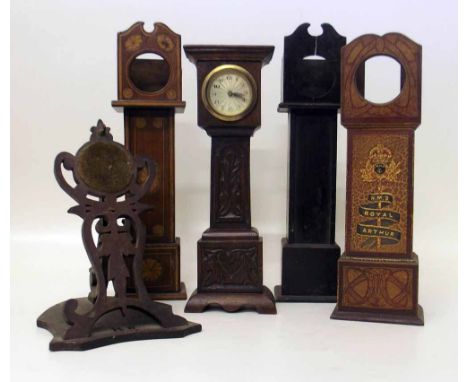 Three "long cased clock" pocket watch holders; another with a balance wheel movement; an easel watch holder (5). Condition re