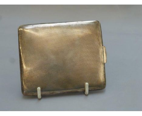 A silver cigarette case with engine turned decoration, maker - Smith and Bartlan, Birmingham, 1936.