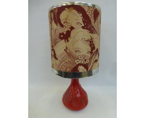 A 1960s shaped pottery lamp base with a designed lamp shade decorated with semi clad young ladies.