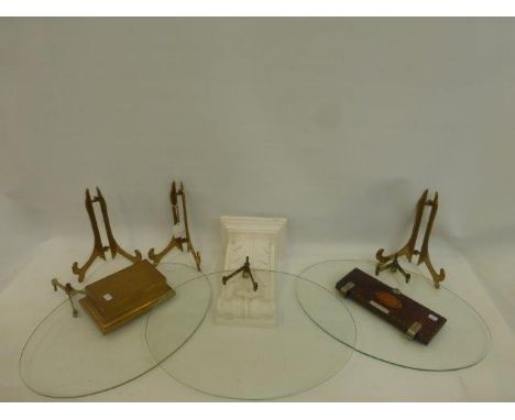 A set of three oval glass shop display shelves, a Meakers London parquetry inlaid tie press, a gilt decorated cigarette box w