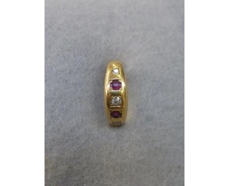 An 18ct gold ruby and diamond gypsy style ring, size I.