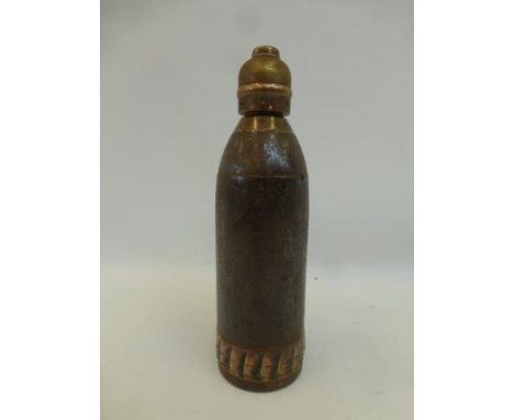 A military time and percussion fuse shell case complete with nose timer, stamped 1-12-1900 to the case.