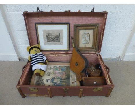 A canvas and wood bound trunk with an assortment of mixed collectables.