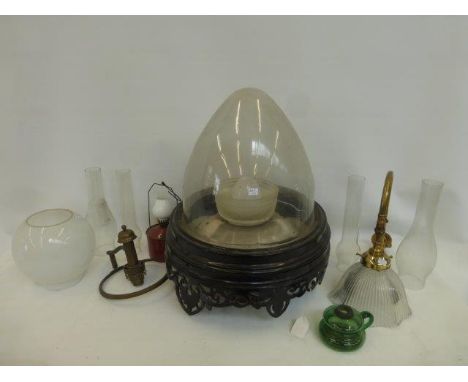 A large ceiling light with pierced decoration with bullet shaped glass shade, and an assortment of light fixtures including a
