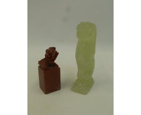 A carved jade figure of a mythical lion fish and a carved soapstone dog of foe.