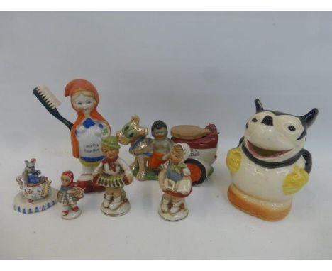 An assortment of novelty ceramic figurines including a Little Red Riding Hood toothbrush holder.