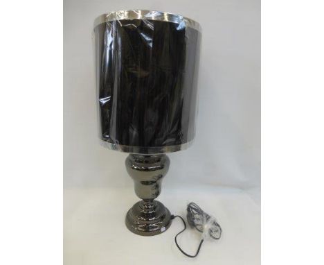 A large contemporary baluster table lamp with black pleated shade.