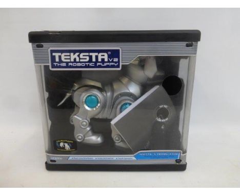 A Wowwee Teksta V2 Robotic Puppy, with user manual.