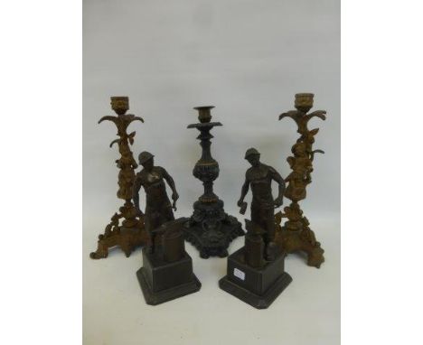 A pair of gilt spelter candlesticks and one other candlestick, also a pair of bronze figures depicting blacksmiths at work.
