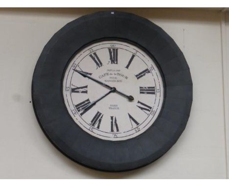 A large novelty circular battery operated wall clock.