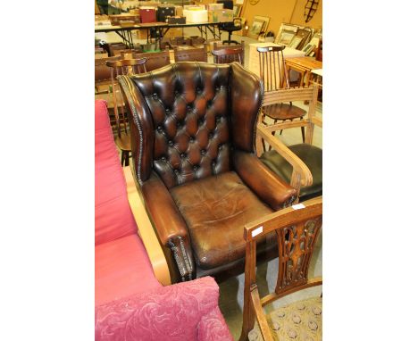 Leather button back winged armchair