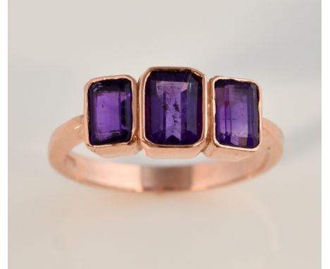 Contemporary ring set with three step cut amethysts in rose gold, 9 ct ,ring size O 