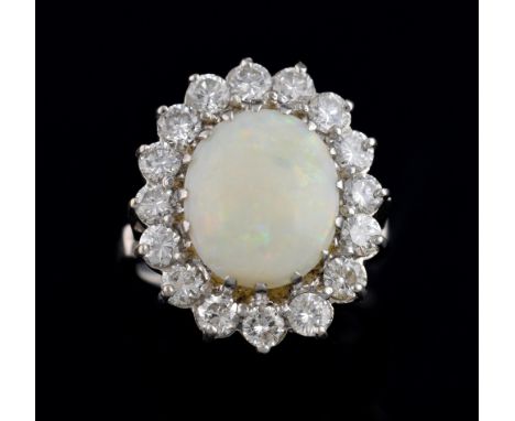 Opal and diamond set ring, with central white opal within a band of brilliant cut diamonds, total diamond weight estimated at