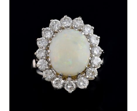 Opal and diamond set ring, with central white opal within a band of brilliant cut diamonds, total diamond weight estimated at