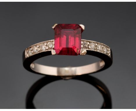 A ruby and diamond set ring the rectangular step cut ruby, estimated at 1.43 carats, with diamond set shoulders 