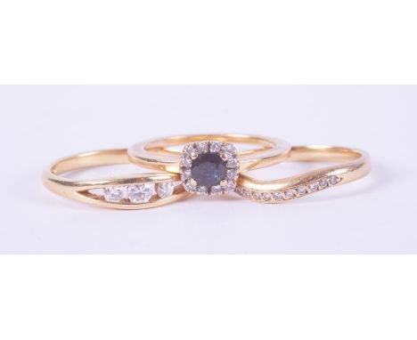 Three 18ct yellow gold rings to include a cluster style ring set with a sapphire, approx. 0.25 carats and surrounded by small