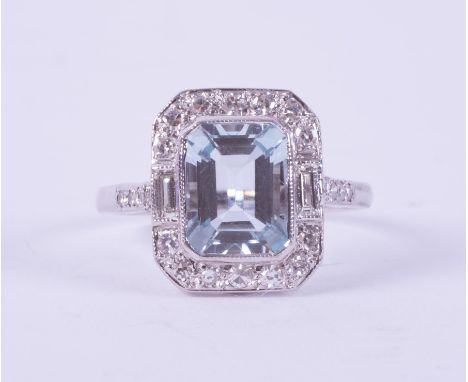 A fine 18ct white gold Art Deco style ring set with a central emerald cut Aquamarine, approx. 2.50 carats, with a baguette cu