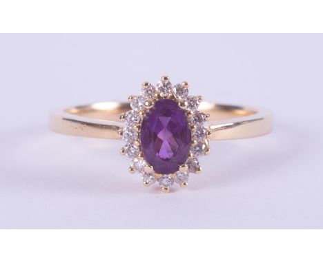 An 18ct yellow gold cluster style ring set with a central oval cut amethyst, approx. 0.43 carats, surrounded by small round c