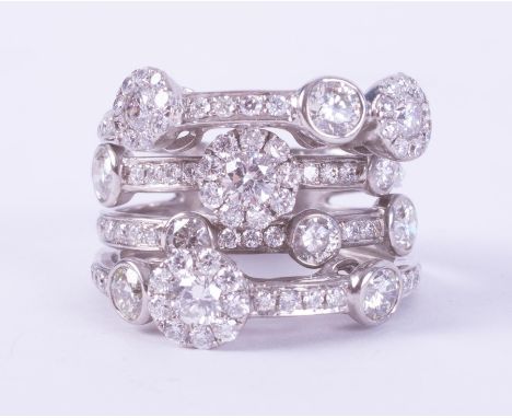 A white gold (not hallmarked or tested) multi-row ring set with round brilliant cut diamonds, approx. total diamond weight 3.