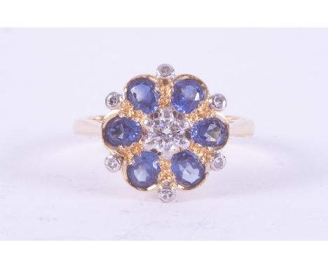 An 18ct yellow gold flower design ring set with six oval cut sapphires, total weight approx. 0.90 carats, with one central ro